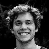 Man smiling, fair hair, close-up, outdoors.
